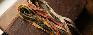 A silk bookmark ribbon laid across an old leather binding