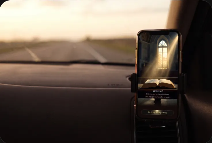 A phone in a car mount playing a chapter on an empty road at sunrise